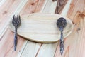 Wooden plates, wooden fork, wooden spoon on wood background Royalty Free Stock Photo