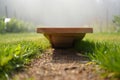 Wooden platform on a grassy path with soft background blur Royalty Free Stock Photo
