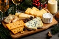 A wooden platter featuring various cheeses, crackers, and wine drinks, set against a festive background Royalty Free Stock Photo