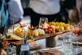 Wooden platter with gourmet appetizers on a restaurant table Royalty Free Stock Photo