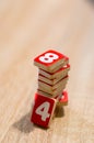 Wooden play cards in red with numbers on it on a table Royalty Free Stock Photo