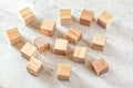 15 wooden playing cubes on white board