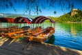 Wooden Pletna boats and castle in background, Bled, Slovenia