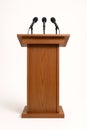 Wooden podium with Microphones in Minimalist White Background Setting Royalty Free Stock Photo