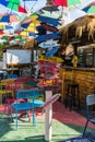 Wooden pointing arrows in the street Cafe in Ksamil, Albania