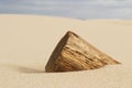 Wooden Pole Buried in Sand
