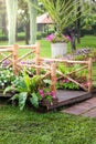 Wooden pole, pathway and flower garden Royalty Free Stock Photo