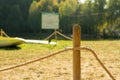 Wooden pole with rope with green grass background