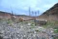 Stones with a wooden pole delimiting a terrain in a mountain area. Royalty Free Stock Photo