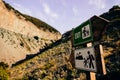 Wooden pole with tourist signs in the form of arrows on a mountain route with the words `Exit