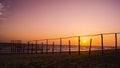 Wooden poles on the beach at sunset glow Royalty Free Stock Photo