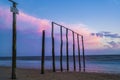 Wooden poles on the beach at sunset glow Royalty Free Stock Photo