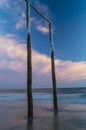 Wooden poles on the beach at sunset glow Royalty Free Stock Photo