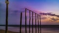 Wooden poles on the beach at sunset glow Royalty Free Stock Photo