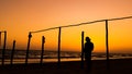 Wooden poles on the beach at sunset glow Royalty Free Stock Photo