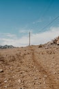 Wooden poles with electrical wires in mountainous region. Spread of electricity to hard-to-reach areas Royalty Free Stock Photo