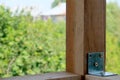 Wooden poles fixed by metal corner with screws over green nature blurred background Royalty Free Stock Photo