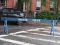 A wooden police barricade closing off the street.