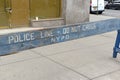 Wooden police barrier with white stenciled lettering Royalty Free Stock Photo