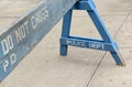 Wooden police barrier with white stenciled lettering