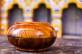 Wooden polished monk`s alms bowl in the courryard of a dzong monastery in Bhutan