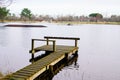 Wooden pontoon in water reflection sunset sun in lake mirror image