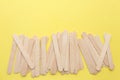 Wooden popsicle sticks on yellow background. Ice cream wooden sticks,Ice lolly sticks. Royalty Free Stock Photo