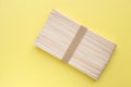 Wooden popsicle sticks on yellow background. Ice cream wooden sticks,Ice lolly sticks. Royalty Free Stock Photo