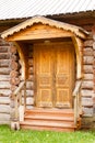 Wooden porch entrance door with architectural decorative elements wood carving of old Russian house Royalty Free Stock Photo