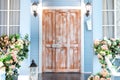 Wooden porch of house with different flowers. House entrance staircase at home decorated for easter. Royalty Free Stock Photo
