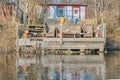 Wooden porch by the water in a traditional Scandinavian summer house conveys minimalism and intimacy with cosy Nordic vibes