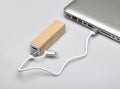 Wooden portable external power bank, for emergency phone recharge.