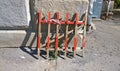 Wooden portable road fence stands against a concrete wall