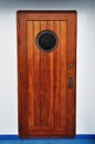 Wooden Porthole door in a ship/cruise. Royalty Free Stock Photo