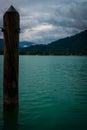 Wooden post against the background of Tegernsee Lake and mountains. Germany.