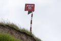 wooden post on a cliff. on it is the inscription Area 51