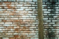 Wooden post in front of worn brick wall surface, urban street backgrounds and textures Royalty Free Stock Photo