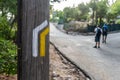 Wooden post with lines of yellow and white paint, indicative PR signs for hikers and walkers. Royalty Free Stock Photo