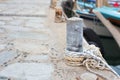 Wooden post with mooring ropes for tying boats and ships Royalty Free Stock Photo