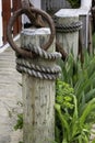 Wooden post and rope on wharf Royalty Free Stock Photo