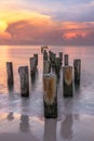 Wooden posts on the sandy beach at sunset. Naples Beach, Florida Royalty Free Stock Photo