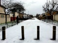 Wooden posts on the snowy pathway near the Becontree housing estate in Barking and Dagenham borough