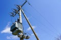 Wooden power line pole with electric transformer in rural area