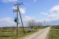 Wooden power line pole with electric transformer in rural area