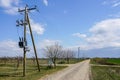 Wooden power line pole with electric transformer in rural area