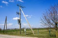 Wooden power line pole with electric transformer in rural area