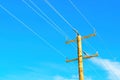 Wooden Power Pole with Wires Against Blue Sky Royalty Free Stock Photo