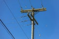 Wooden power utility pole and clear blue sky. Electric pole power lines and wires on the blue sky Background Royalty Free Stock Photo