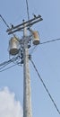 Wooden power utility pole with transformers and cables. Royalty Free Stock Photo