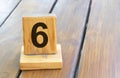 Wooden priority number 6 on a plank tab